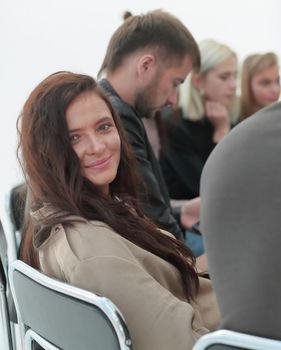 close up. young woman sitting in a circle of her friends