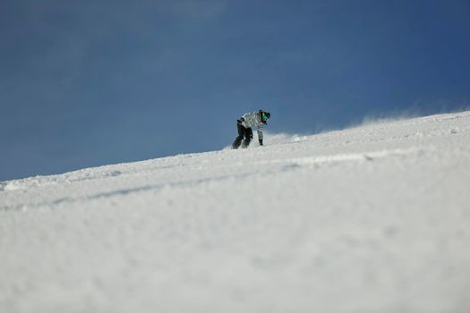 snowboard woman racing downhill slope and freeride on powder snow at winter season and sunny day