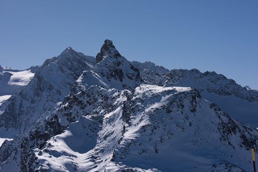 mountain landscape at winter with fresh snow on beautiful sunny day at french alps