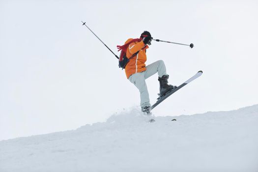 man ski free ride downhill at winter season on beautiful sunny day and powder snow