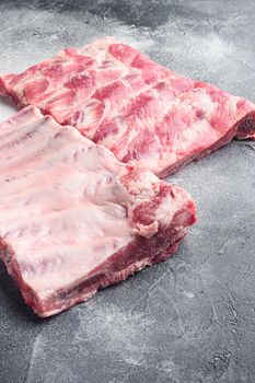 Fresh rack of raw pork spare ribs set, on gray stone background