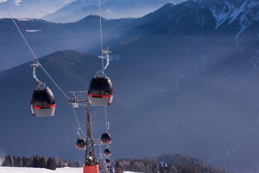 modern gondola lift at ski resort on sunny winter day