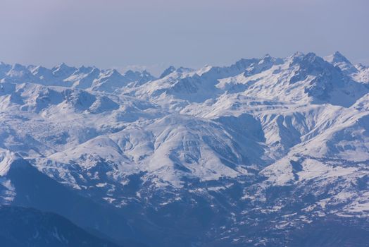 mountain landscape at winter with fresh snow on beautiful sunny day at french alps