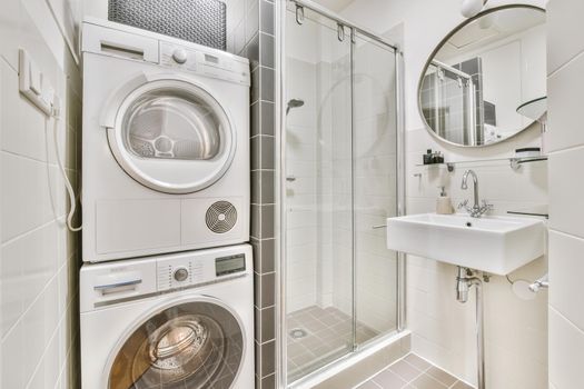Bright bathroom with washing machine and dryer