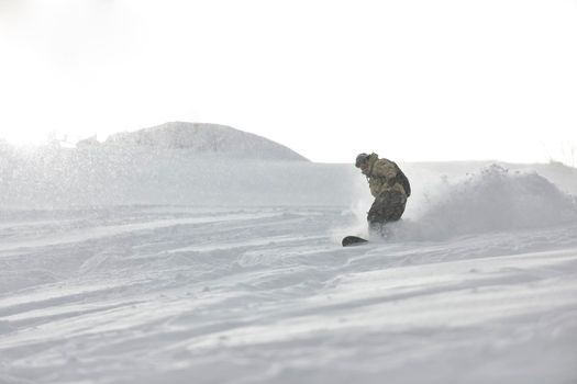 freestyle snowboarder jump and ride free style  at sunny winter day on mountain