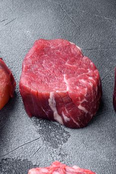Fillet Mignon tenderloin raw meat veal and beef steaks set, on gray stone background