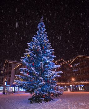 a view on snowy streets of the Alpine mountain village in the cold winter night