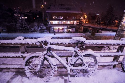 end of biking season.parked bicycle covered by snow from a heavy snowstorm.Winter cycling