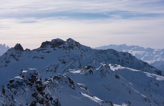 mountain landscape at winter with fresh snow on beautiful sunny day at french alps