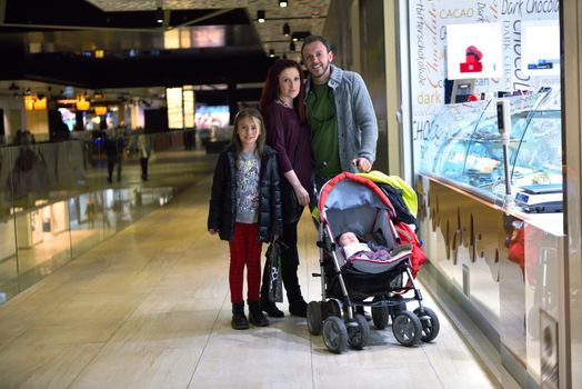 happy young family portrait in shopping mall