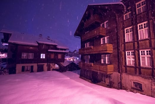 a view on snowy streets of the Alpine mountain village in the cold winter night