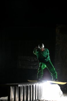 young free style snowboarder jumping in air and make acrobations