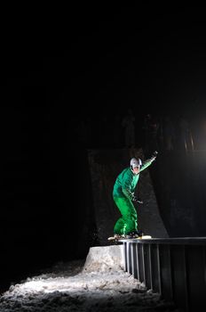 young free style snowboarder jumping in air and make acrobations