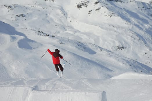 jumping skier at mountain winter snow fresh suny day