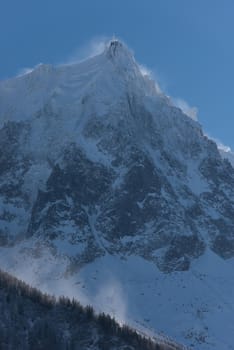 French alps mountain peaks covered with fresh snow. Winter landscape nature scene on beautiful sunny winter day.