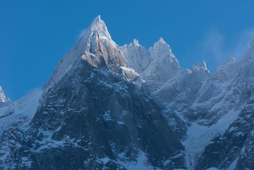 French alps mountain peaks covered with fresh snow. Winter landscape nature scene on beautiful sunny winter day.