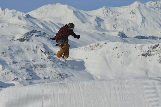 jumping skier at mountain winter snow fresh suny day