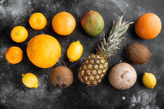 Fresh tropical fruit set, on black dark stone table background, top view flat lay