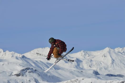 jumping skier at mountain winter snow fresh suny day