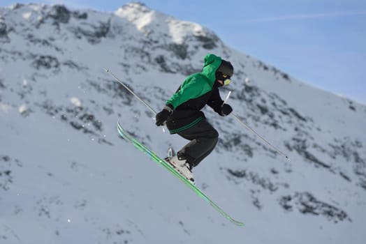 jumping skier at mountain winter snow fresh suny day