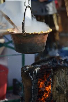 polenta food prepared on traditional recipe with fire and woods on height mountain alps at winter season at beautiful sunny day