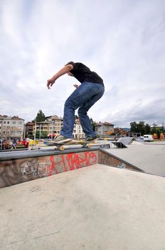 Boy practicing skate in a skate park - isolated