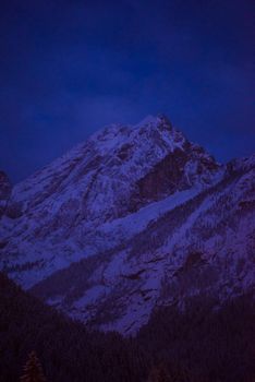 mountain village in alps  at night in winte  with fresh snow