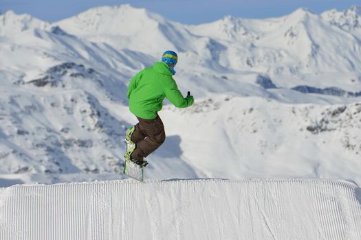 jumping skier at mountain winter snow fresh suny day