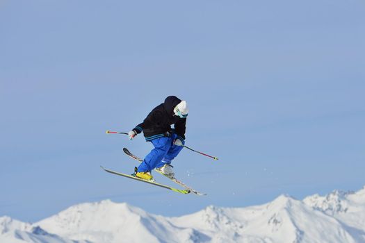 jumping skier at mountain winter snow fresh suny day