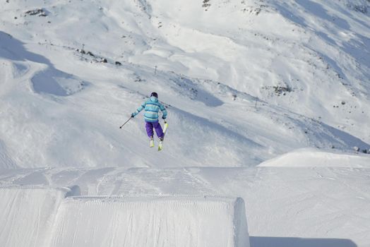 jumping skier at mountain winter snow fresh suny day