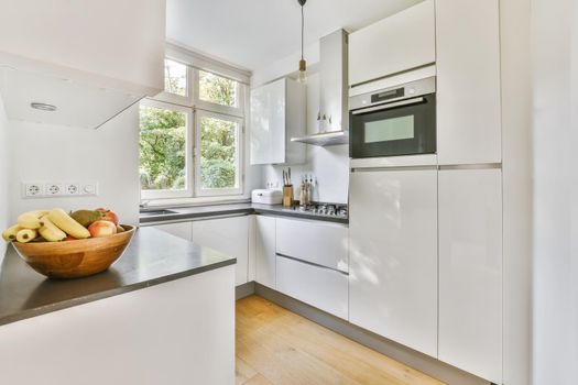Small cozy bright kitchen with a window to the street