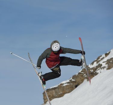 jumping skier at mountain winter snow fresh suny day