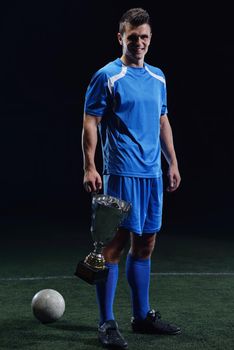 soccer player doing kick with ball on football stadium  field  isolated on black background