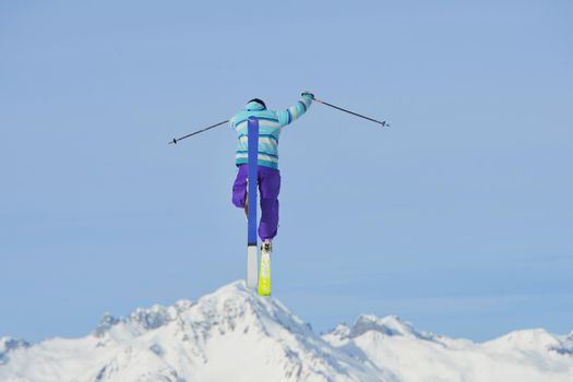 jumping skier at mountain winter snow fresh suny day