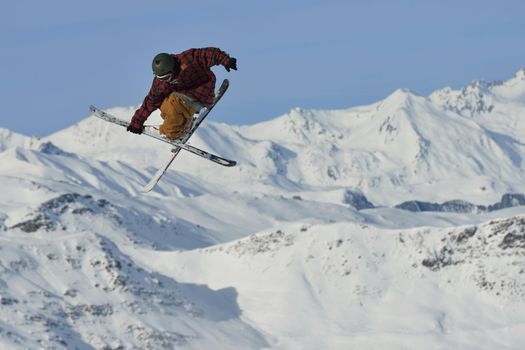 jumping skier at mountain winter snow fresh suny day