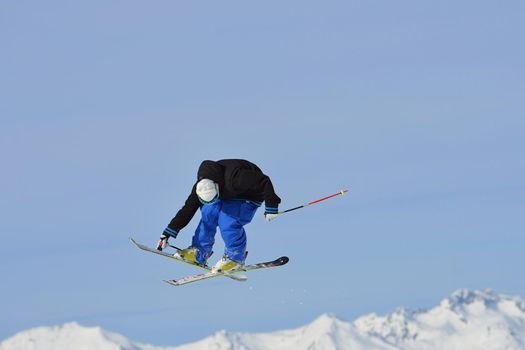 jumping skier at mountain winter snow fresh suny day