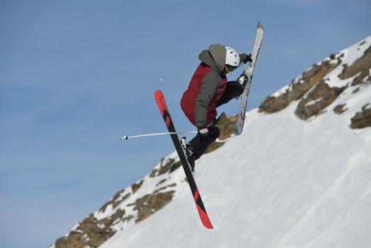 jumping skier at mountain winter snow fresh suny day