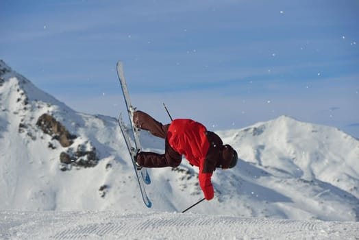 jumping skier at mountain winter snow fresh suny day