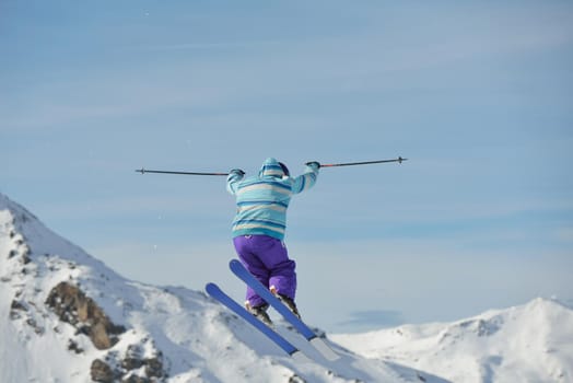 jumping skier at mountain winter snow fresh suny day