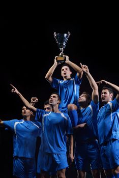 soccer players team group celebrating the victory and become champion of game while holding win coup