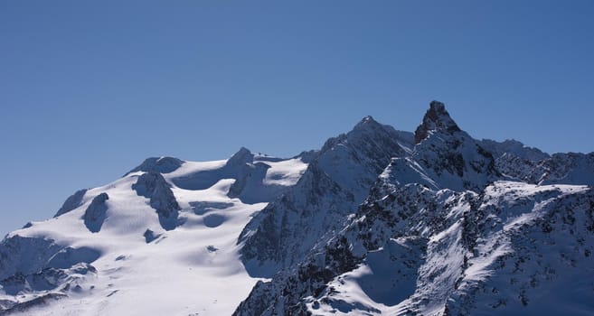 mountain landscape at winter with fresh snow on beautiful sunny day at french alps