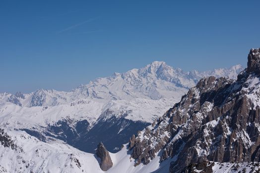 mountain landscape at winter with fresh snow on beautiful sunny day at french alps