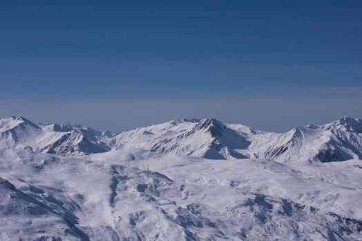 mountain landscape at winter with fresh snow on beautiful sunny day at french alps