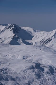 mountain landscape at winter with fresh snow on beautiful sunny day at french alps