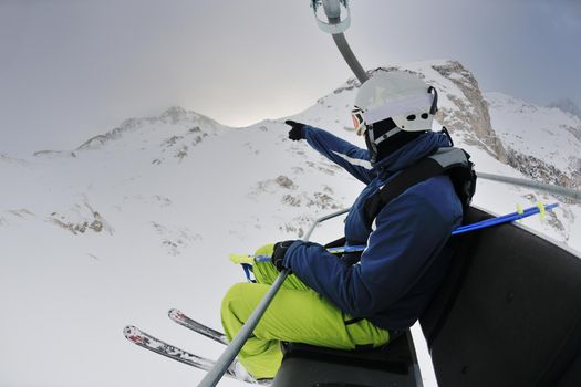 skier skiing downhill on fresh powder snow  with sun and mountains in background