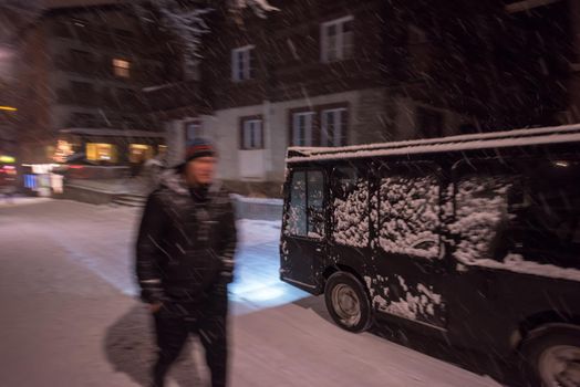 a view on snowy streets of the Alpine mountain village in the cold winter night