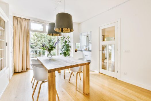 Stylish cozy light dining room with comfortable chairs