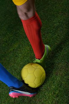 soccer player doing kick with ball on football stadium  field  isolated on black background