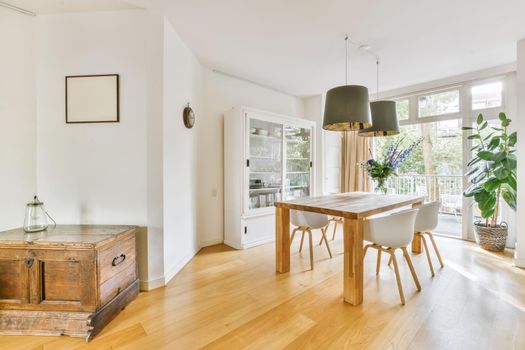 Stylish cozy light dining room with comfortable chairs