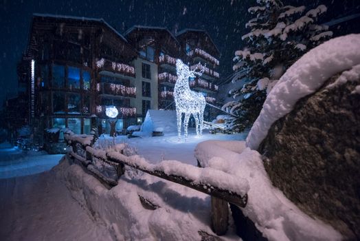 a view on snowy streets of the Alpine mountain village in the cold winter night